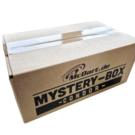 McDart Condor Mystery Box Auf dem Bild ist ein brauner Karton mit der Aufschrift "McDart.de Mystery-Box Condor" zu sehen. Der Karton ist mit Klebeband versiegelt.